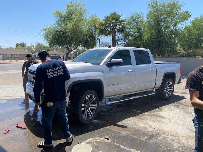 Encanto crew hand washing a truck